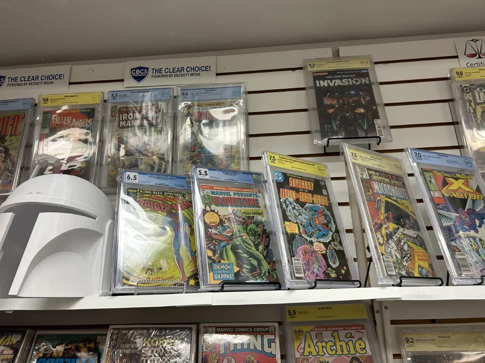 Graded comics in slabs along a shop wall