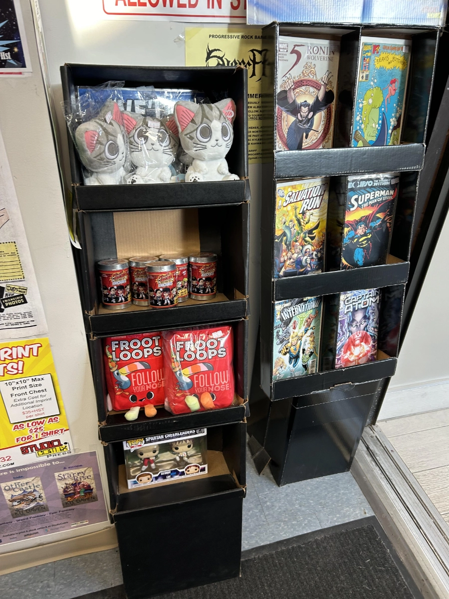 A shop fixture holding comics, cards and boxed collectibles
